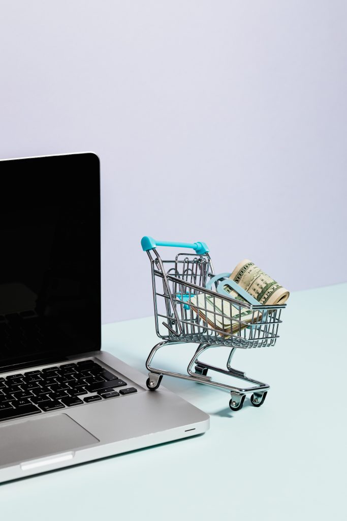 Photo by Karolina Grabowska: https://www.pexels.com/photo/shopping-cart-with-money-on-top-of-a-laptop-5632379/