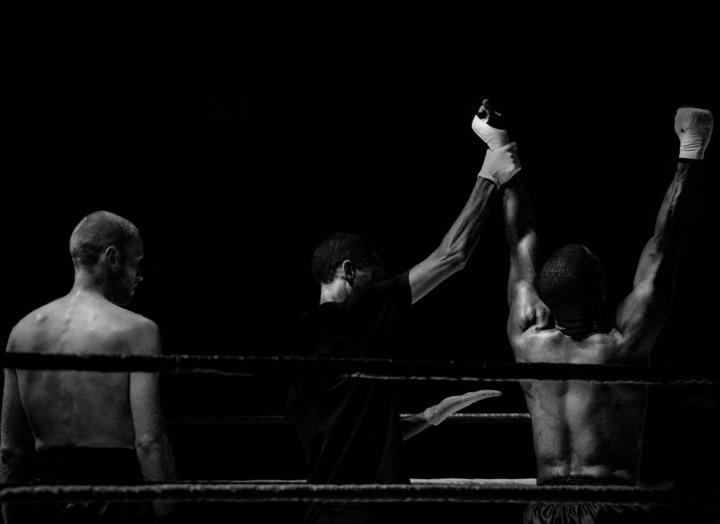 Photo by Skitterphoto: https://www.pexels.com/photo/grayscale-photography-of-man-holding-boxer-s-hand-inside-battle-ring-3797/